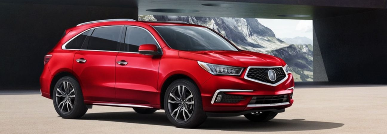 2020 acura mdx parked beside a snowy mountain